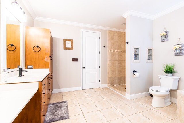 bathroom with tile patterned floors, a tile shower, vanity, crown molding, and toilet