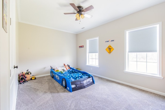 bedroom with carpet flooring, ceiling fan, and crown molding