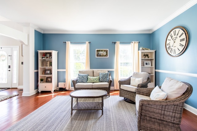 sitting room with wood-type flooring and ornamental molding