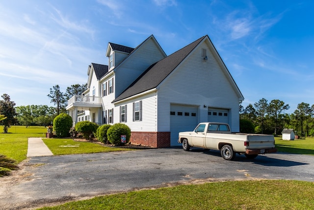 view of side of property featuring a yard and a balcony