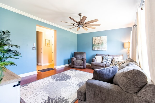 living room with wood-type flooring, ceiling fan, and ornamental molding