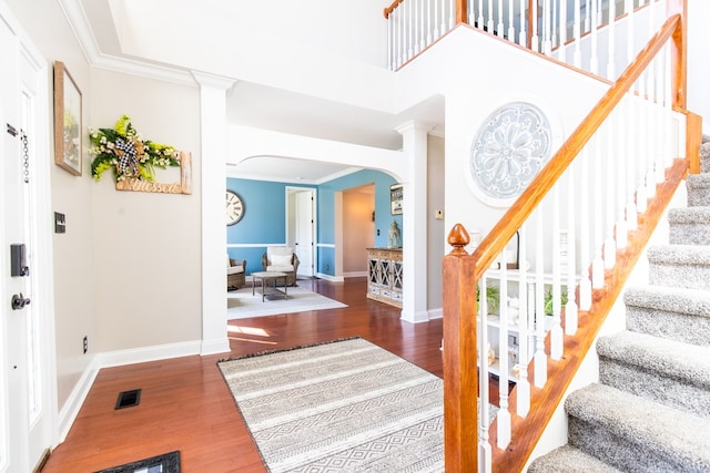 entrance foyer featuring dark hardwood / wood-style flooring and crown molding