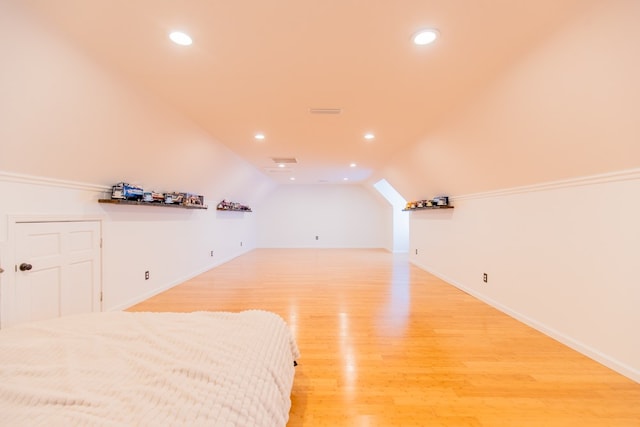 bedroom with light hardwood / wood-style flooring and vaulted ceiling