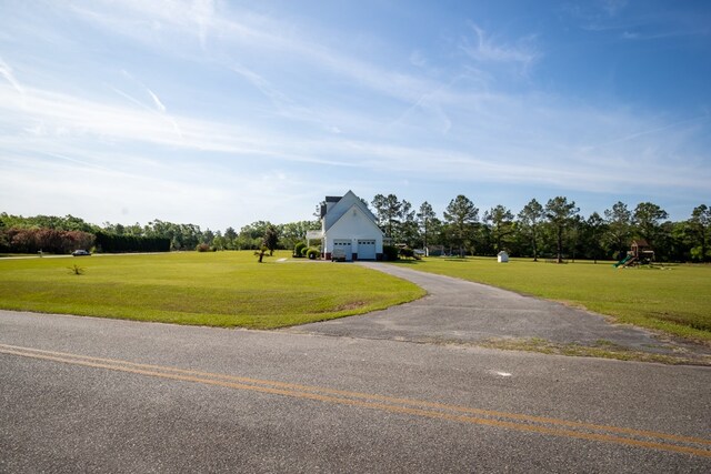 view of front of property featuring a garage and a front lawn