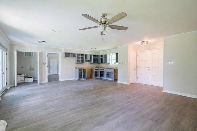 2019 Falling Leaf Ln, Valdosta, GA 31602 - unfurnished living room featuring a ceiling fan, ornamental molding, and light wood-style floors