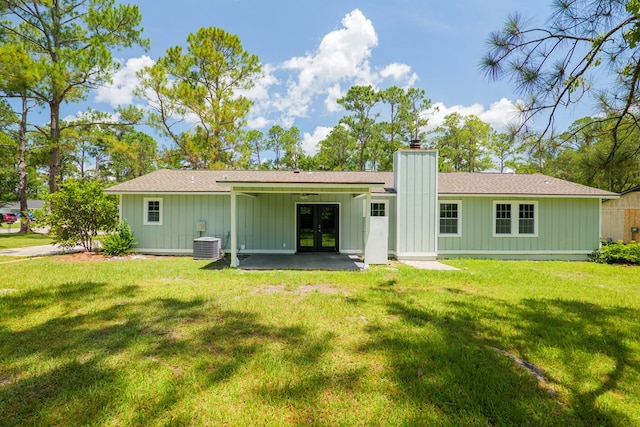 2019 Falling Leaf Ln, Valdosta, GA 31602 - back of house with french doors, a chimney, board and batten siding, and a lawn