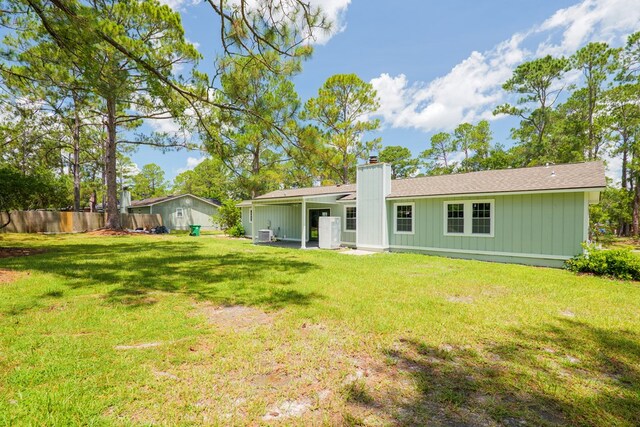 2019 Falling Leaf Ln, Valdosta, GA 31602 - back of house with a chimney and board and batten siding