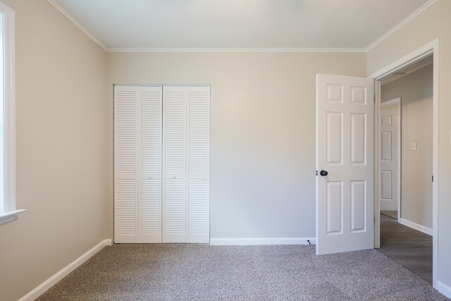 2019 Falling Leaf Ln, Valdosta, GA 31602 - unfurnished bedroom with crown molding, carpet flooring, and a closet