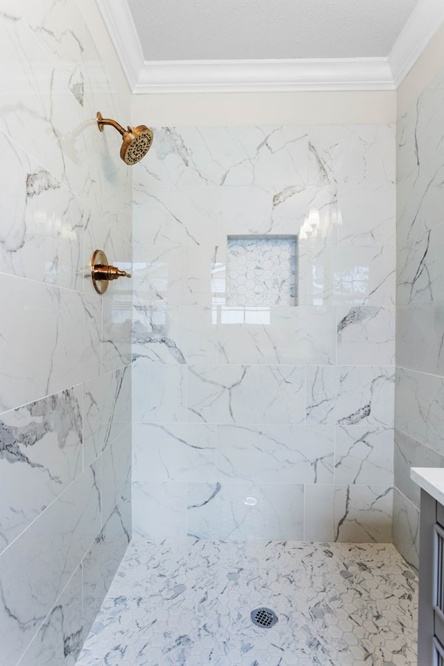 full bathroom with tiled shower and crown molding