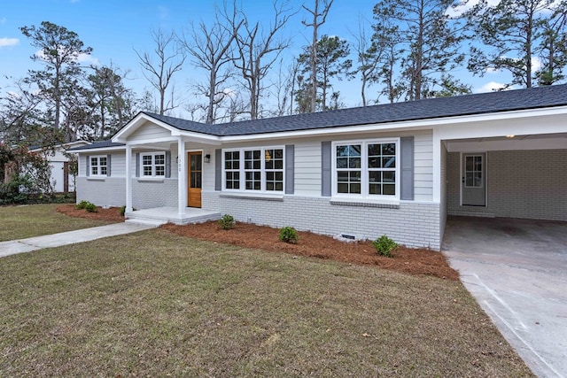 ranch-style home with driveway, brick siding, crawl space, a carport, and a front yard