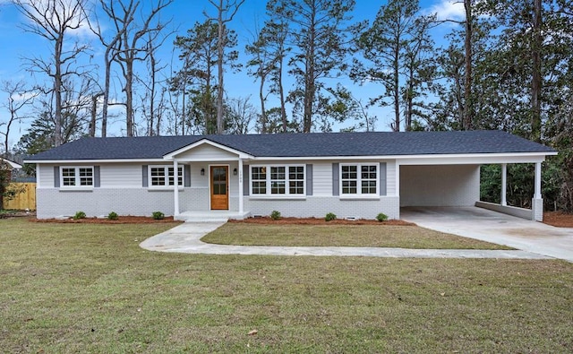 single story home featuring driveway, brick siding, a front yard, and an attached carport