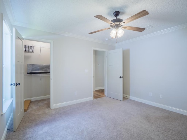 5674 Clydetta Dr, Lake Park, GA 31636 - unfurnished bedroom with carpet flooring, crown molding, a walk in closet, a closet, and ceiling fan