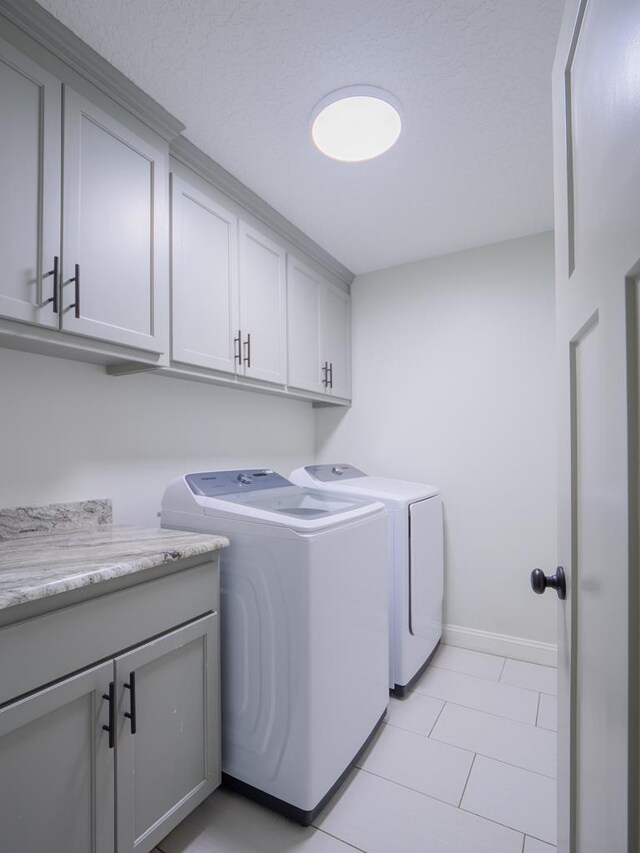 5674 Clydetta Dr, Lake Park, GA 31636 - laundry room featuring independent washer and dryer, cabinet space, baseboards, and light tile patterned floors