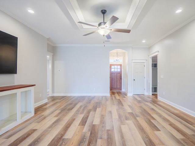 5674 Clydetta Dr, Lake Park, GA 31636 - unfurnished living room with light wood-style floors, arched walkways, crown molding, a ceiling fan, and a raised ceiling