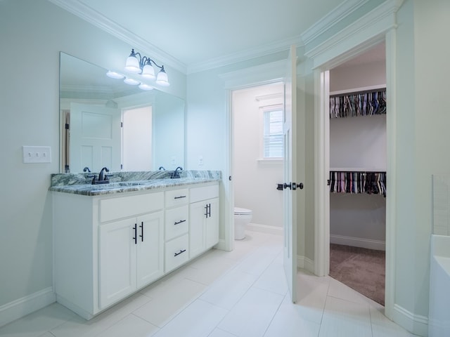 5674 Clydetta Dr, Lake Park, GA 31636 - full bathroom with double vanity, toilet, crown molding, a walk in closet, and baseboards