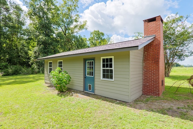 view of outbuilding with a yard