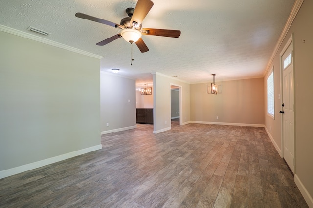 unfurnished room featuring dark hardwood / wood-style floors, ornamental molding, a textured ceiling, and ceiling fan with notable chandelier