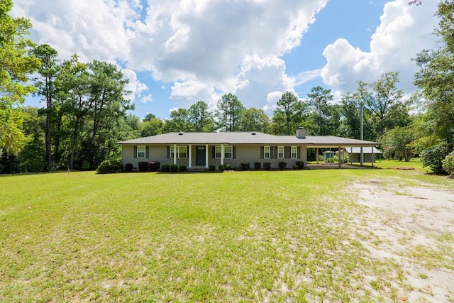 rear view of house featuring a yard and a carport