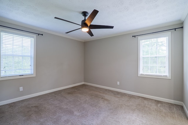 carpeted spare room featuring a textured ceiling, plenty of natural light, ornamental molding, and ceiling fan