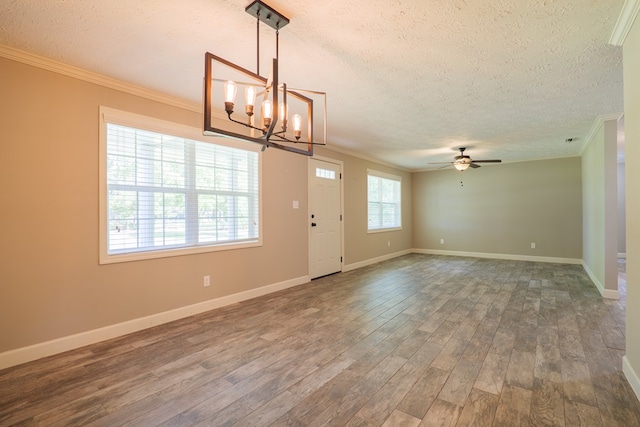 entryway with a textured ceiling, ceiling fan with notable chandelier, dark hardwood / wood-style floors, and ornamental molding