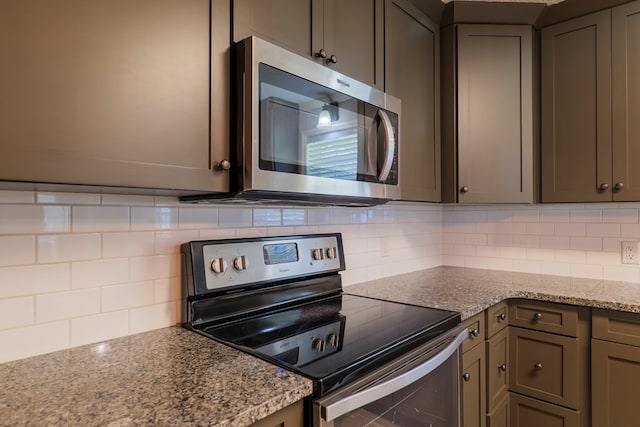 kitchen featuring gray cabinetry, decorative backsplash, black electric range, and light stone counters