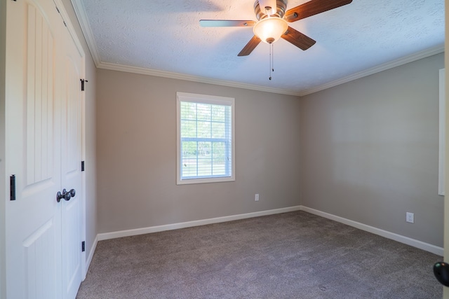 unfurnished room with carpet, a textured ceiling, ceiling fan, and ornamental molding