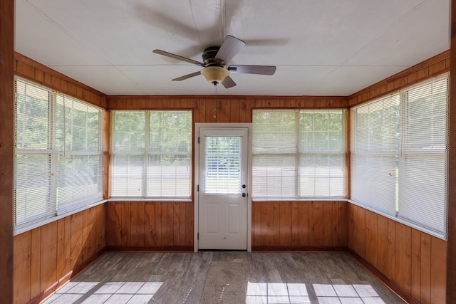 unfurnished sunroom featuring a wealth of natural light and ceiling fan