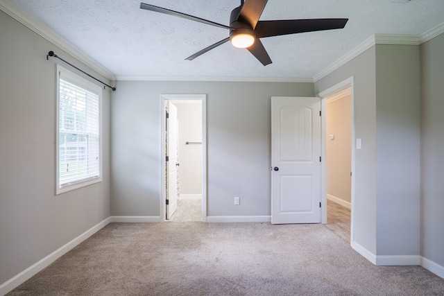 unfurnished bedroom with light carpet, a textured ceiling, ceiling fan, and ornamental molding