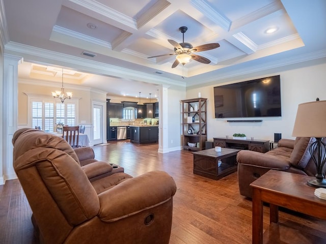 living area featuring ceiling fan with notable chandelier, dark wood-style flooring, visible vents, decorative columns, and crown molding