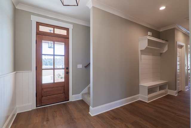 foyer with ornamental molding and dark hardwood / wood-style floors