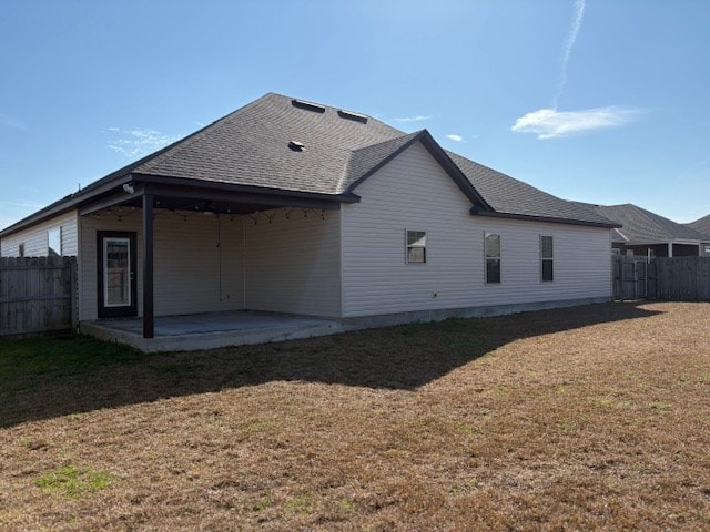 back of property featuring a patio and a yard