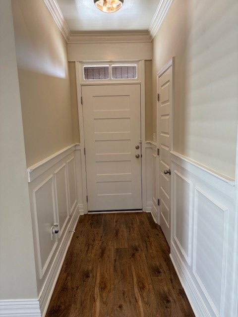 doorway featuring ornamental molding and dark hardwood / wood-style floors