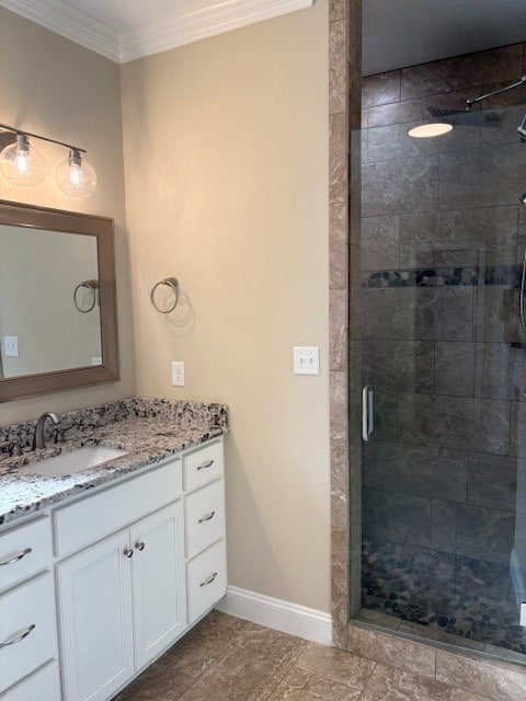 bathroom featuring ornamental molding, an enclosed shower, and vanity