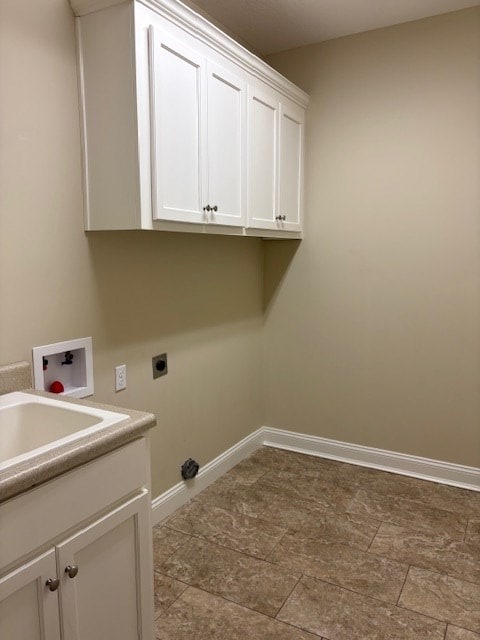 washroom featuring cabinets, hookup for a washing machine, sink, and hookup for an electric dryer