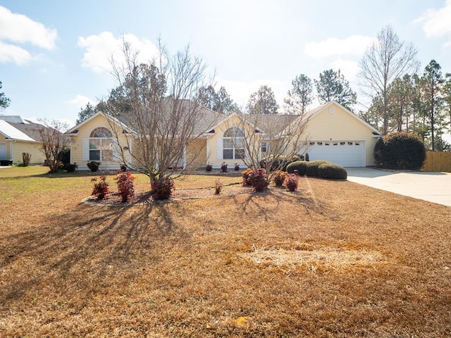 ranch-style home with a garage and a front lawn