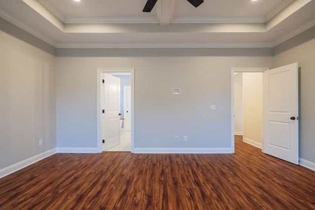 unfurnished room with baseboards, a raised ceiling, and wood finished floors