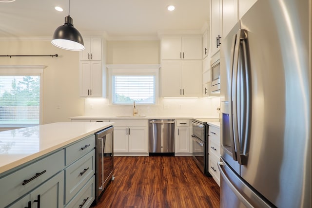 kitchen with beverage cooler, appliances with stainless steel finishes, light countertops, and dark wood-style flooring