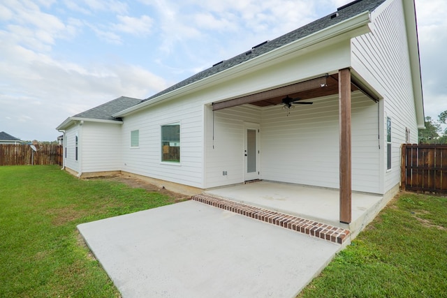 exterior space with a patio, a yard, fence, and a ceiling fan