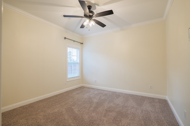 carpeted spare room with baseboards, ornamental molding, and a ceiling fan