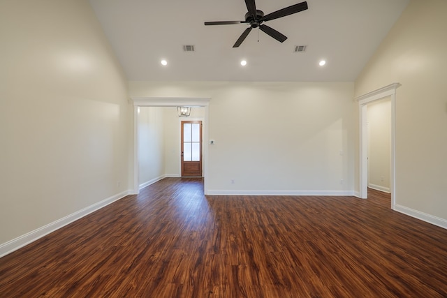 spare room with dark wood-style floors, visible vents, ceiling fan, and baseboards