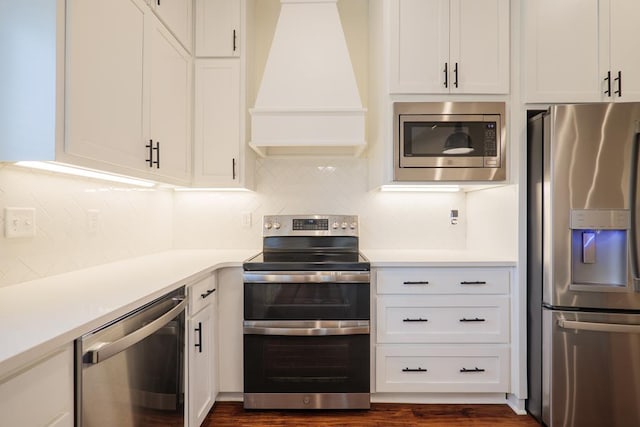 kitchen featuring premium range hood, white cabinetry, stainless steel appliances, and light countertops