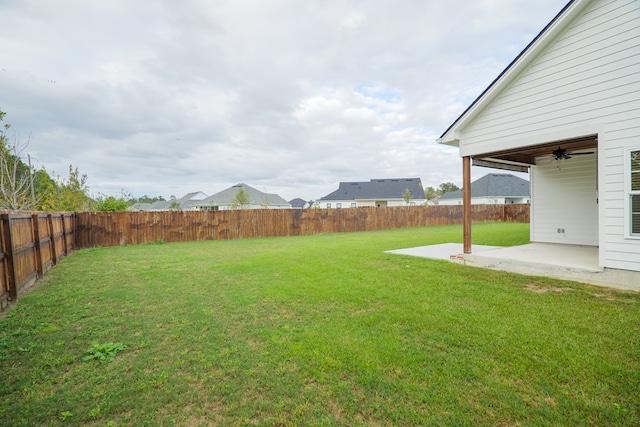 view of yard featuring ceiling fan, a patio area, and a fenced backyard