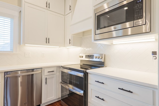 kitchen with stainless steel appliances, light countertops, custom exhaust hood, and tasteful backsplash