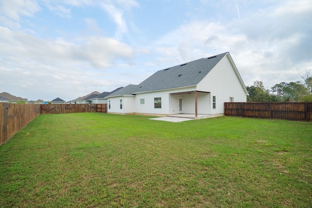 back of property featuring a patio, a lawn, and a fenced backyard