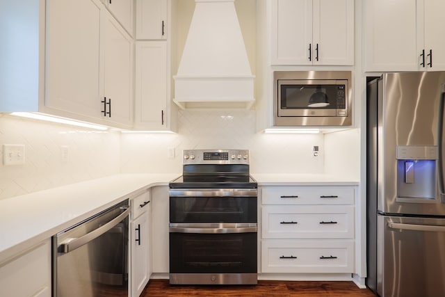 kitchen with white cabinetry, custom exhaust hood, stainless steel appliances, and light countertops