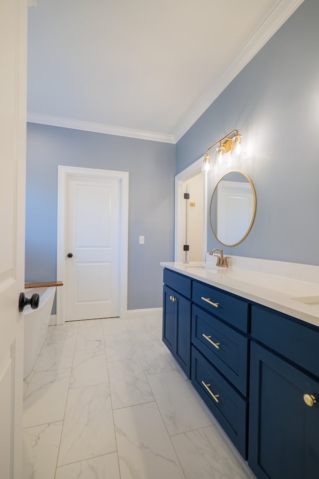 bathroom featuring double vanity, a tub to relax in, ornamental molding, marble finish floor, and a sink