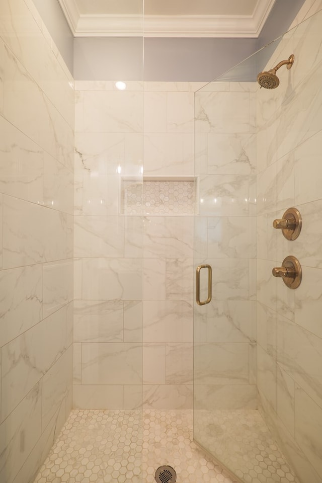 bathroom featuring a stall shower and crown molding