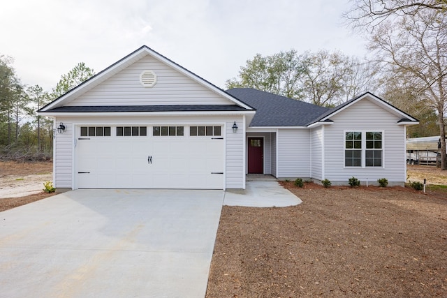 ranch-style house featuring driveway, an attached garage, and roof with shingles