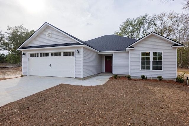 ranch-style house with driveway, an attached garage, and a shingled roof