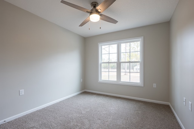 empty room featuring carpet floors, ceiling fan, baseboards, and a textured ceiling